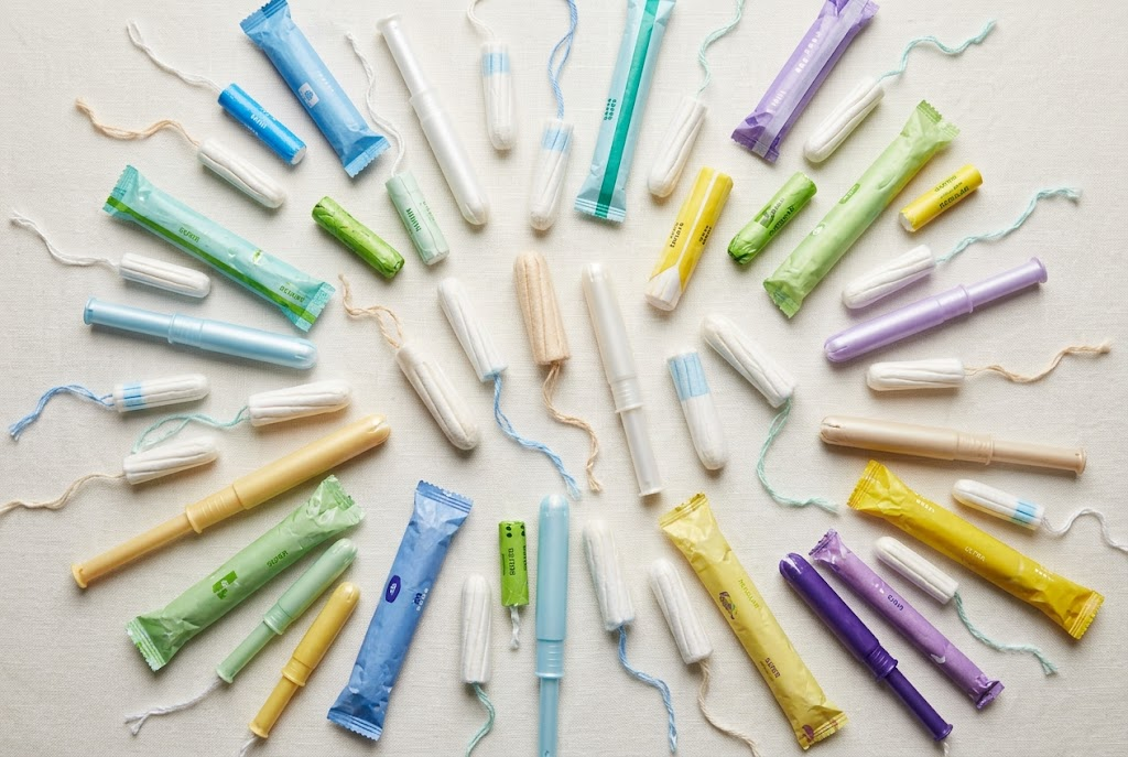 Tampon and other period care products alongside information about menstrual product safety research